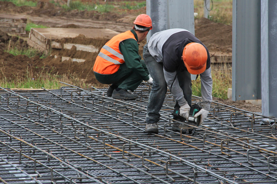 concrete rebar structure being finished prior to pouring concrete for commercial concrete work